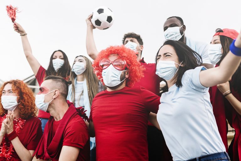 Multiracial group of friends wearing protective face mask screaming and watching soccer match at stadium during the coronavirus pandemic – New normal for live sports conceptNSF Recap: Best Practices for The Ultimate Sports and Entertainment Experiences